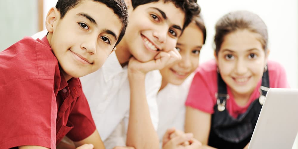 A parent helping a school-age child with books, representing a family preparing for a school transfer in the UAE